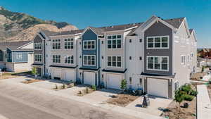 View of front of home with driveway and an attached garage