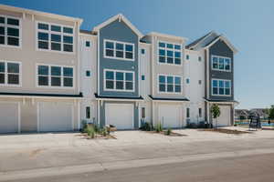 View of front facade with driveway and a garage