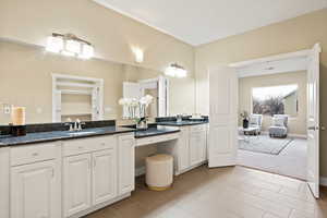 Full bath featuring double vanity and light colored carpet