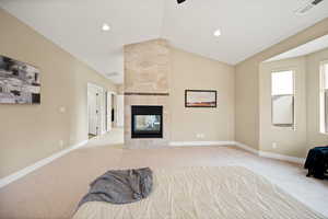 Unfurnished bedroom with carpet flooring, a fireplace, and vaulted ceiling
