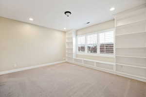 Spare room featuring light carpet and recessed lighting