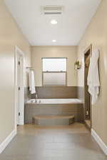 Full bathroom featuring a garden tub, recessed lighting, and a shower stall