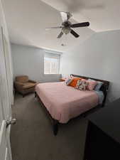 Carpeted bedroom with ceiling fan