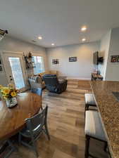 Dining area featuring wood finished floors and recessed lighting