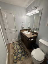 Bathroom featuring vanity, light wood-type flooring, and a textured ceiling
