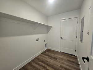 Laundry area with dark wood-style flooring, electric dryer hookup, washer hookup, and electric panel