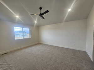 Carpeted empty room featuring a ceiling fan and recessed lighting