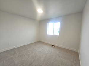 Spare room with baseboards and carpet flooring