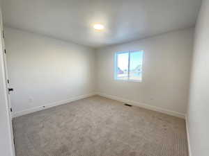 Spare room with carpet floors and baseboards