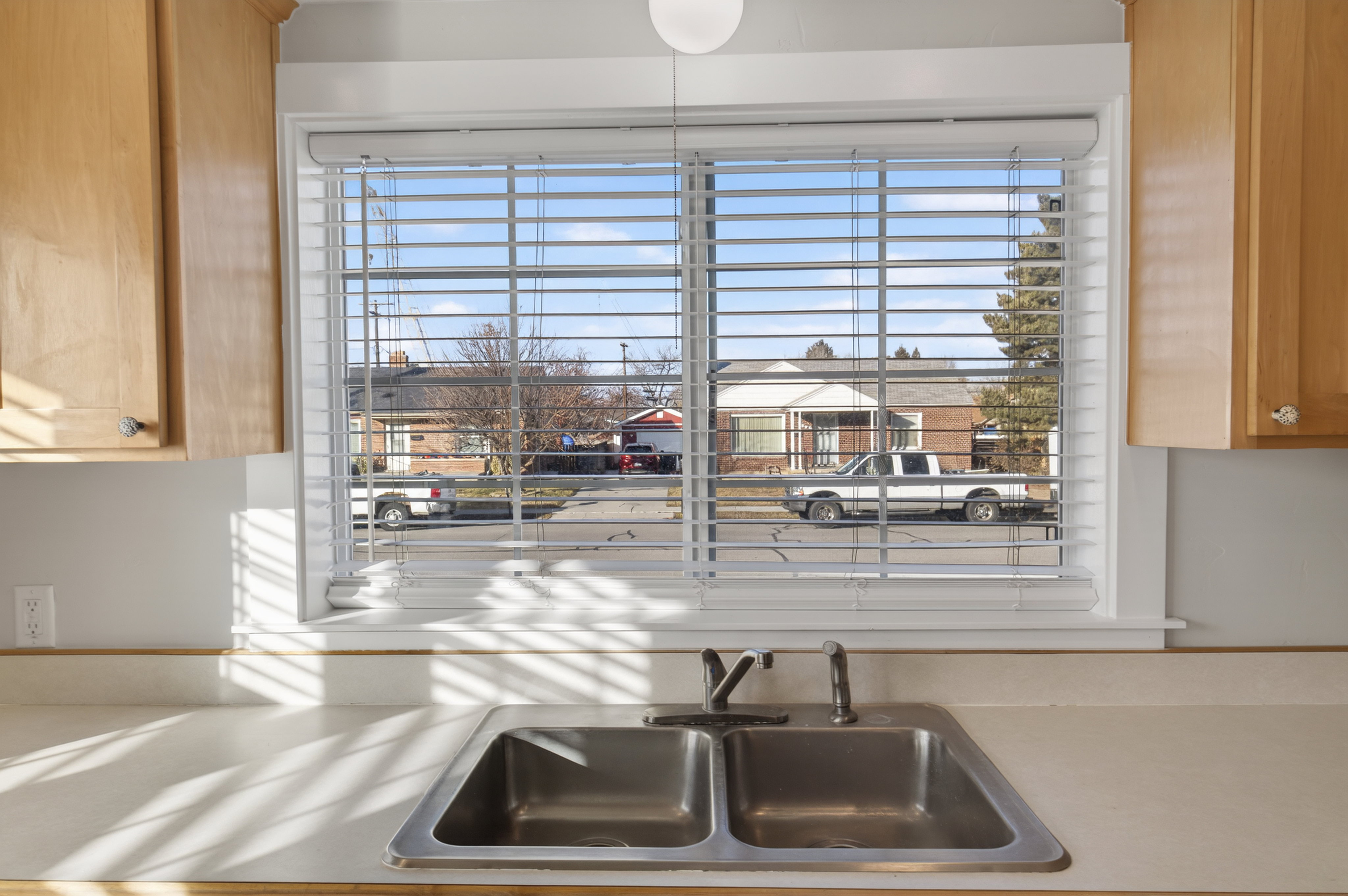 Kitchen view of light countertops and a sink