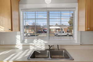 Kitchen view of light countertops and a sink