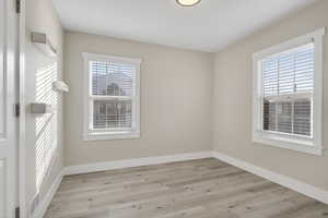 Unfurnished room featuring light wood-style floors and plenty of natural light