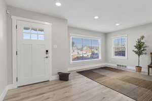 Foyer featuring plenty of natural light, light wood-style flooring, and recessed lighting