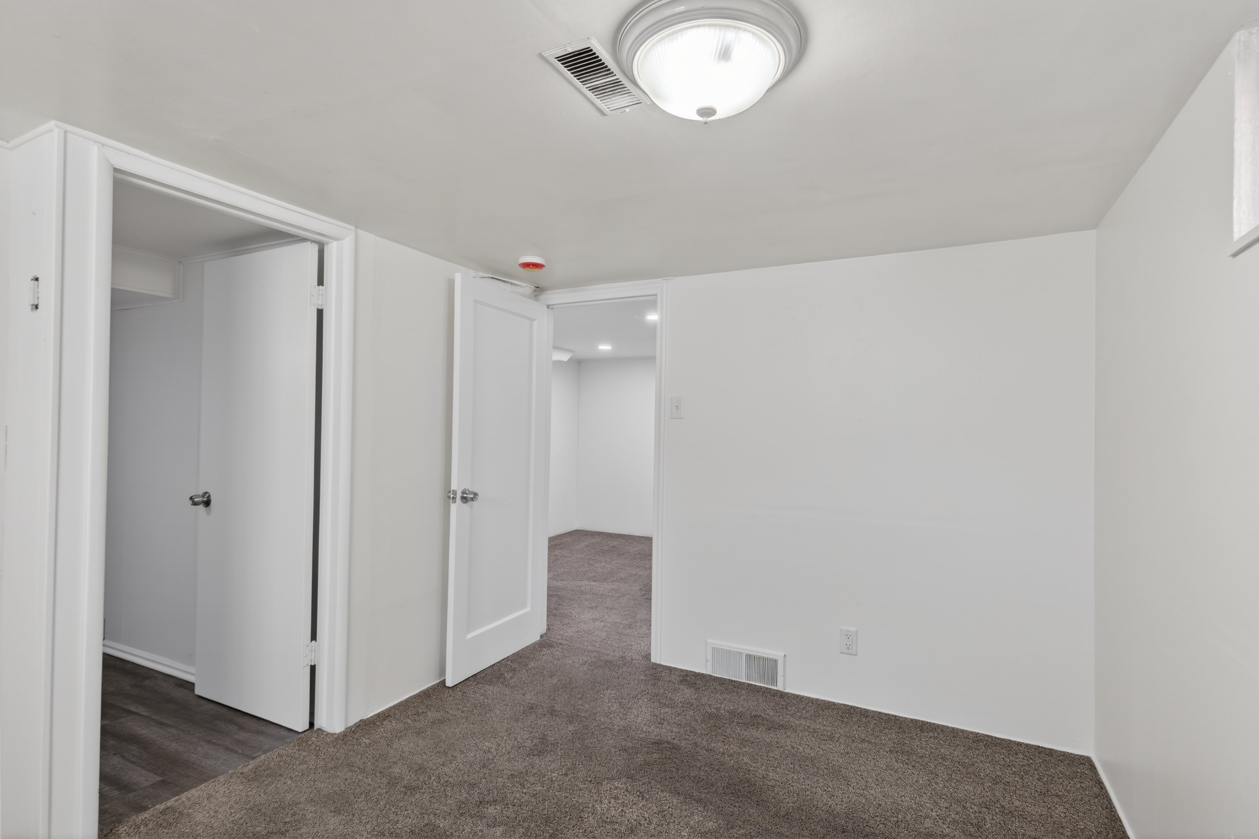 Spare room featuring dark colored carpet