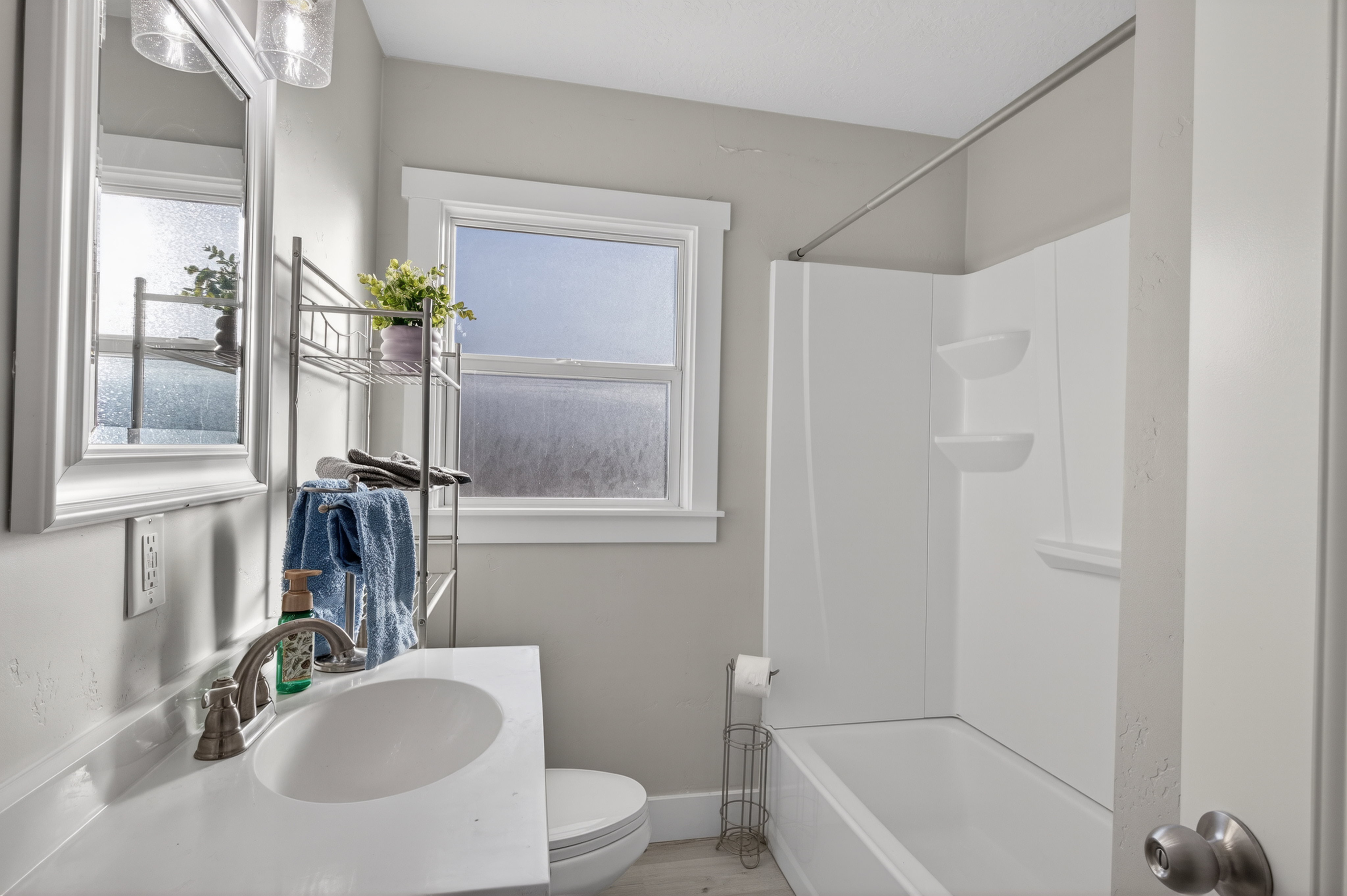 Full bathroom featuring vanity, washtub / shower combination, and wood finished floors