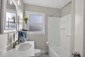 Full bathroom featuring vanity, washtub / shower combination, and wood finished floors