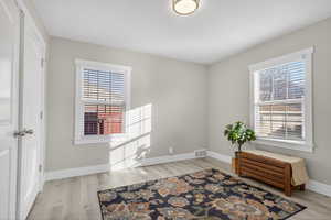 Sitting room featuring light wood-type flooring and baseboards