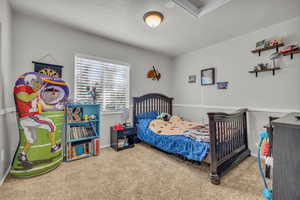 Bedroom featuring carpet and a textured ceiling