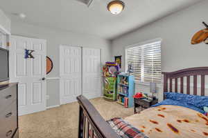 Bedroom featuring a closet and light carpet