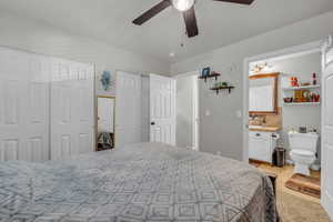 Bedroom featuring multiple closets and ceiling fan