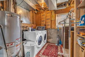 Laundry area with gas water heater and washing machine and dryer