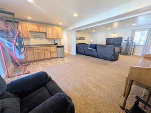 Living room featuring recessed lighting, light colored carpet, and light tile patterned floors