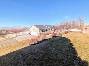 View of front of property with concrete driveway, brick siding, and an attached garage