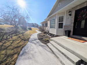 View of property exterior featuring a lawn