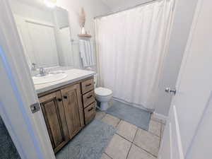 Full bath featuring vanity and light tile patterned floors