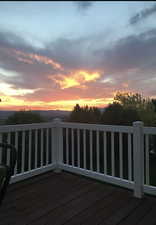 Deck at dusk featuring a balcony