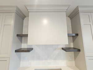 Kitchen featuring open shelves and tasteful backsplash