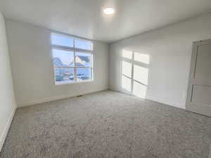 Empty room featuring baseboards and carpet floors