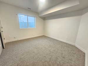 Unfurnished bedroom featuring baseboards and carpet flooring