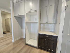 Mudroom with baseboards and light wood finished floors