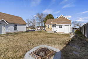 Back of property featuring a patio and a shingled roof