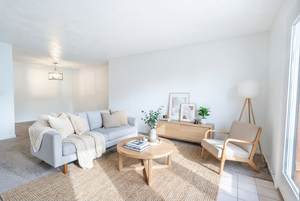 Living area featuring carpet flooring and baseboards