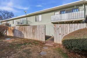 View of side of home featuring a balcony