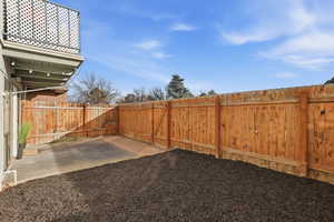 Fenced backyard featuring a patio