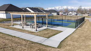 View of home's community with a pergola, a tennis court, a patio area, a mountain view, and a residential view