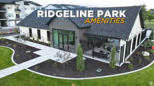 Rear view of house with a shingled roof, board and batten siding, and a yard