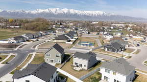 Aerial perspective of suburban area featuring a mountain backdrop