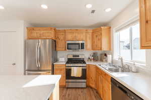 Kitchen featuring stainless steel appliances, light wood finished floors, light wood finish cabinetry, and recessed lighting