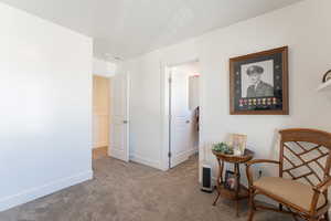 Living area with carpet floors and baseboards