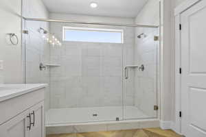 Bathroom with vanity and a stall shower