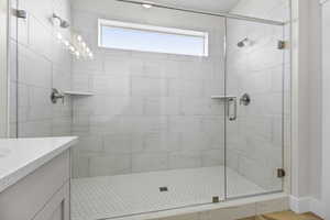 Full bathroom with a stall shower and vanity