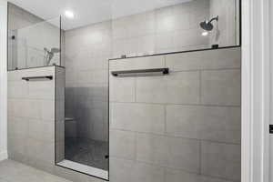 Primary Full bathroom with a walk in shower and recessed lighting