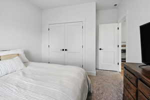 Upstairs Bedroom 2 with a closet and carpet floors