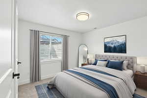 Basement Bedroom 2 with light colored carpet and baseboards