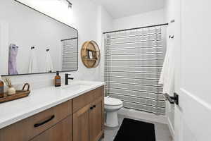 Upstairs Full Bathroom featuring curtained shower and vanity