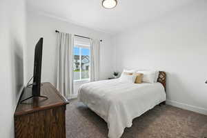 Upstairs Bedroom 2 with carpet floors and baseboards